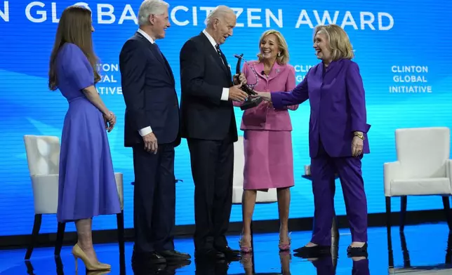 President Joe Biden is presented with the Global Citizen Award by Chelsea Clinton, former President Bill Clinton, first lady Jill Biden and former Secretary of State Hillary Clinton at the Clinton Global Initiative Monday, Sept. 23, 2024, in New York. (AP Photo/Manuel Balce Ceneta)