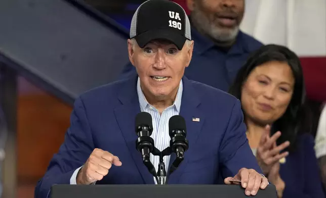 President Joe Biden wears a union hat as he speaks during a visit to the U.A. Local 190 Training Center in Ann Arbor, Mich., Friday, Sept. 6, 2024. (AP Photo/Paul Sancya)