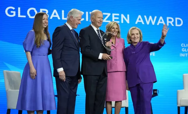 President Joe Biden is presented with the Global Citizen Award by Chelsea Clinton, former President Bill Clinton, first lady Jill Biden and former Secretary of State Hillary Clinton at the Clinton Global Initiative Monday, Sept. 23, 2024, in New York. (AP Photo/Manuel Balce Ceneta)