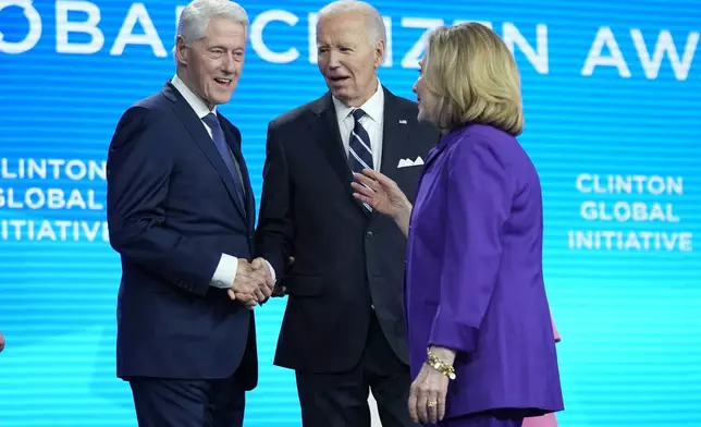 President Joe Biden talks with former Secretary of State Hillary Clinton and former President Bill Clinton as he is presented with the Global Citizen Award at the Clinton Global Initiative Monday, Sept. 23, 2024, in New York. (AP Photo/Manuel Balce Ceneta)