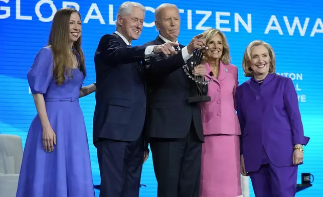 President Joe Biden is presented with the Global Citizen Award by Chelsea Clinton, former President Bill Clinton, first lady Jill Biden and former Secretary of State Hillary Clinton at the Clinton Global Initiative Monday, Sept. 23, 2024, in New York. (AP Photo/Manuel Balce Ceneta)