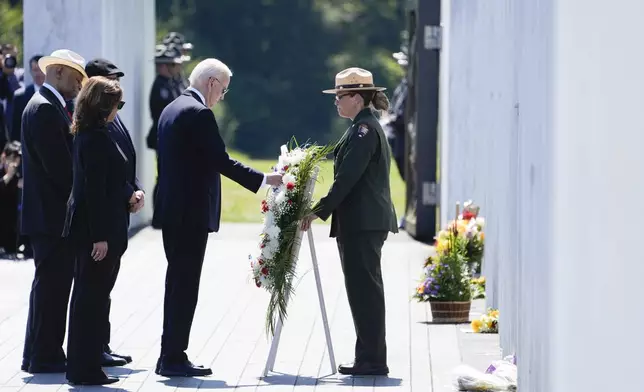 President Joe Biden places a wreath during a ceremony marking the anniversary of the Sept. 11 terror attacks at the Flight 93 National Memorial, Wednesday, Sept. 11, 2024, in Shanksville, Pa., as Democratic presidential nominee Vice President Kamala Harris, left, looks on. (AP Photo/Evan Vucci)