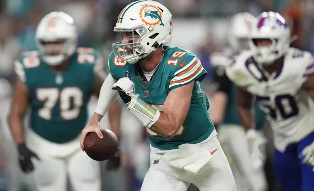 Miami Dolphins quarterback Skylar Thompson (19) runs with the football during the second half of an NFL football game against the Buffalo Bills, Thursday, Sept. 12, 2024, in Miami Gardens, Fla. (AP Photo/Rebecca Blackwell)