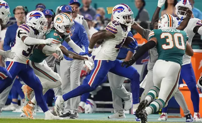 Buffalo Bills cornerback Christian Benford (47) runs after intercepting a pass during the first half of an NFL football game against the Miami Dolphins, Thursday, Sept. 12, 2024, in Miami Gardens, Fla. (AP Photo/Rebecca Blackwell)