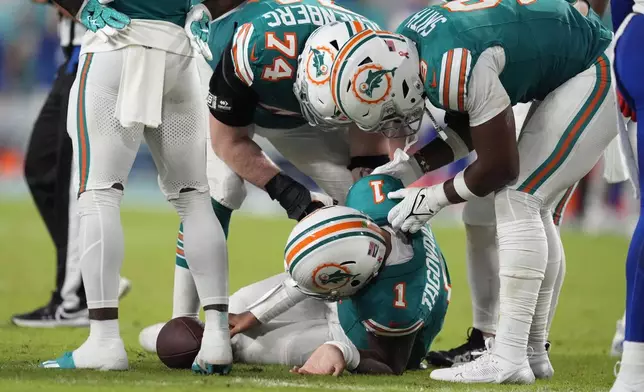 Miami Dolphins quarterback Tua Tagovailoa (1) lies on the field after suffering a concussion during the second half of an NFL football game against the Buffalo Bills, Thursday, Sept. 12, 2024, in Miami Gardens, Fla. (AP Photo/Rebecca Blackwell)