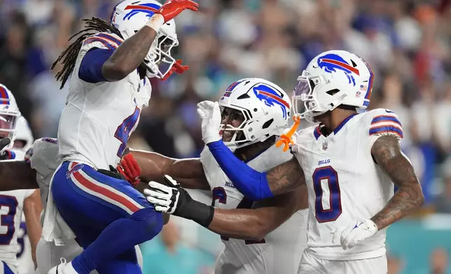 Buffalo Bills running back James Cook (4) celebrates his third touchdown during the first half of an NFL football game against the Miami Dolphins, Thursday, Sept. 12, 2024, in Miami Gardens, Fla. (AP Photo/Rebecca Blackwell)