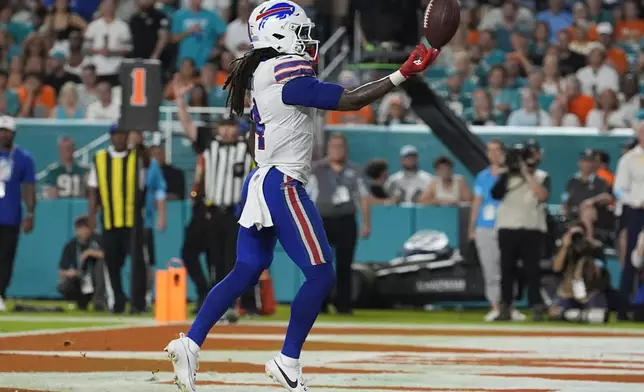 Buffalo Bills running back James Cook (4) scores a touchdown during the first half of an NFL football game against the Miami Dolphins, Thursday, Sept. 12, 2024, in Miami Gardens, Fla. (AP Photo/Lynne Sladky)