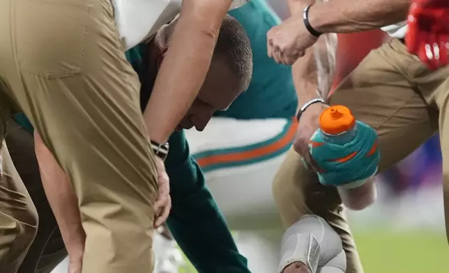 Miami Dolphins quarterback Tua Tagovailoa (1) lies on the field after suffering a concussion during the second half of an NFL football game against the Buffalo Bills, Thursday, Sept. 12, 2024, in Miami Gardens, Fla (AP Photo/Rebecca Blackwell)