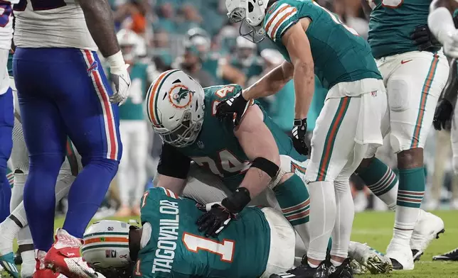 Miami Dolphins quarterback Tua Tagovailoa (1) lies on the field after suffering a concussion during the second half of an NFL football game against the Buffalo Bills, Thursday, Sept. 12, 2024, in Miami Gardens, Fla. (AP Photo/Lynne Sladky)