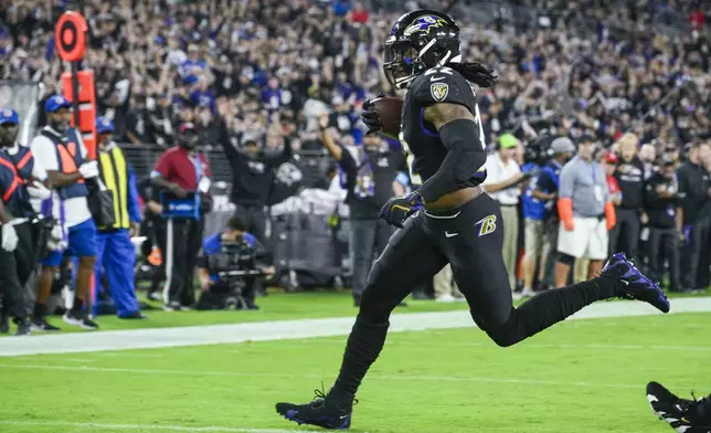 Baltimore Ravens running back Derrick Henry runs for a touchdown after catching a pass from quarterback Lamar Jackson against the Buffalo Bills during the first half of an NFL football game, Sunday, Sept. 29, 2024, in Baltimore. (AP Photo/Nick Wass)