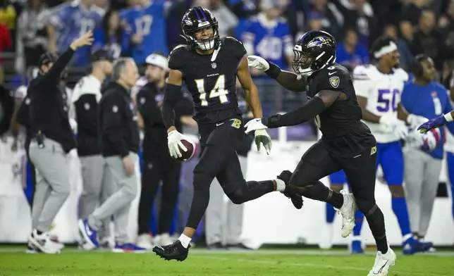 Baltimore Ravens safety Kyle Hamilton (14) reacts with teammate linebacker Roquan Smith after recovering a fumble by Buffalo Bills quarterback Josh Allen during the second half of an NFL football game, Sunday, Sept. 29, 2024, in Baltimore. (AP Photo/Nick Wass)