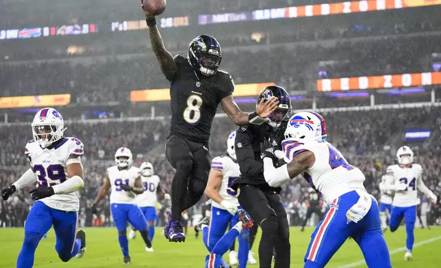 Baltimore Ravens quarterback Lamar Jackson (8) scores a touchdown against the Buffalo Bills during the second half of an NFL football game, Sunday, Sept. 29, 2024, in Baltimore. (AP Photo/Stephanie Scarbrough)