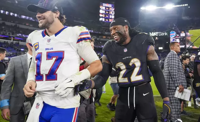 Buffalo Bills quarterback Josh Allen (17) and Baltimore Ravens running back Derrick Henry (22) react following an NFL football game, Sunday, Sept. 29, 2024, in Baltimore. The Ravens won 35-10. (AP Photo/Stephanie Scarbrough)