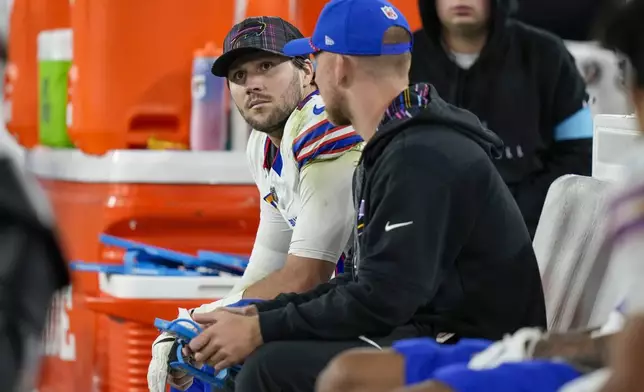 Buffalo Bills quarterback Josh Allen, left, sits on the bench after backup quarterback Mitchell Trubisky took over during the second half of an NFL football game against the Baltimore Ravens, Sunday, Sept. 29, 2024, in Baltimore. (AP Photo/Stephanie Scarbrough)