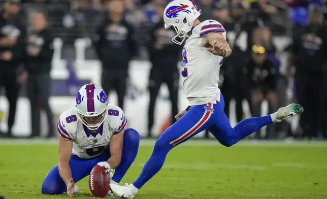 Buffalo Bills kicker Tyler Bass, right, with Sam Martin holding, kicks a field goal against the Baltimore Ravens during the first half of an NFL football game, Sunday, Sept. 29, 2024, in Baltimore. (AP Photo/Stephanie Scarbrough)