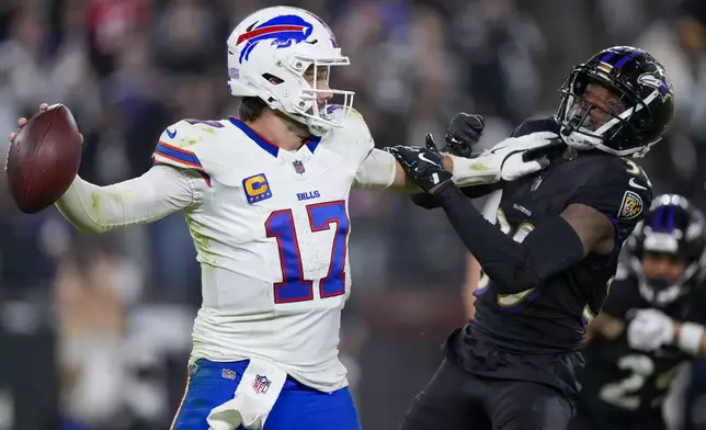 Buffalo Bills quarterback Josh Allen tries to fend off Baltimore Ravens safety Eddie Jackson during the second half of an NFL football game, Sunday, Sept. 29, 2024, in Baltimore. (AP Photo/Stephanie Scarbrough)