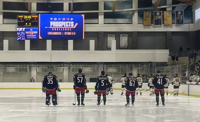 Columbus Blue Jackets line up at their blue line for the national anthem with Boston Bruins before the Sabres Prospects Challenge hockey game in Buffalo, N.Y., Saturday, Sept. 14, 2024. (AP Photo/John Wawrow)