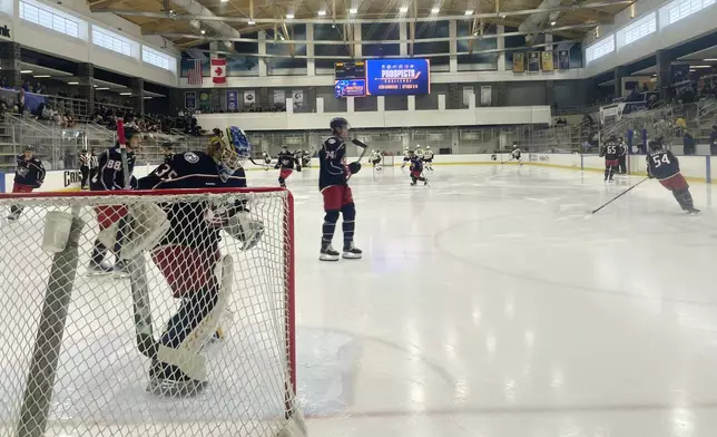 Columbus Blue Jackets goalie Evan Gardner prepares his crease as the Blue Jackets prepares to face the Boston Bruins in a Sabres Prospects Challenge hockey game in Buffalo, N.Y., Saturday, Sept. 14, 2024. (AP Photo/John Wawrow)