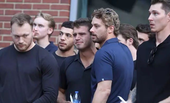 Columbus Blue Jackets player Cole Sillinger, center, reacts during the candlelight vigil to honor Columbus Blue Jackets hockey player Johnny Gaudreau, Thursday, Sept. 4, 2024, outside of Nationwide Arena in Columbus, Ohio. Gaudreau and his brother Matthew were killed by a motor vehicle last week while riding bicycles. (AP Photo/Joe Maiorana)