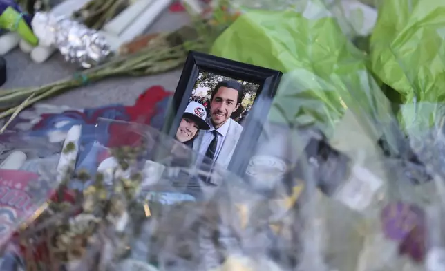 Fans leave mementos as part of the candlelight vigil to honor Columbus Blue Jackets hockey player Johnny Gaudreau, Thursday, Sept. 4, 2024, outside of Nationwide Arena in Columbus, Ohio. Gaudreau and his brother Matthew were killed by a motor vehicle last week while riding bicycles. (AP Photo/Joe Maiorana)