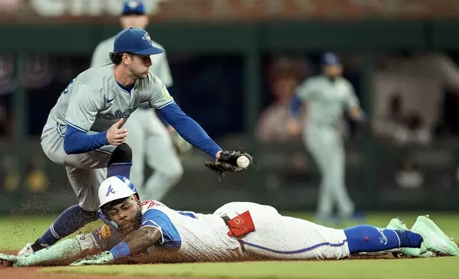 Toronto Blue Jays third baseman Ernie Clement (28) tags Atlanta Braves' Michael Harris II (23) out at second in the fifth inning of a baseball game, Saturday, Sept. 7, 2024, in Atlanta.(AP Photo/Mike Stewart)