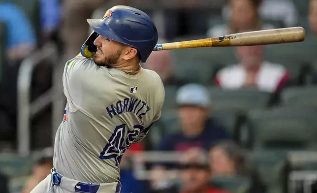 Toronto Blue Jays' Spencer Horwitz (48) hits a solo homer in the first inning of a baseball game against the Atlanta Braves, Saturday, Sept. 7, 2024, in Atlanta.(AP Photo/Mike Stewart)