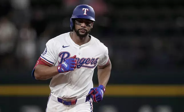 Texas Rangers' Leody Taveras rounds the bases after hitting a two-run home run against the Toronto Blue Jays in the eighth inning of a baseball game in Arlington, Texas, Tuesday, Sept. 17, 2024. (AP Photo/Tony Gutierrez)