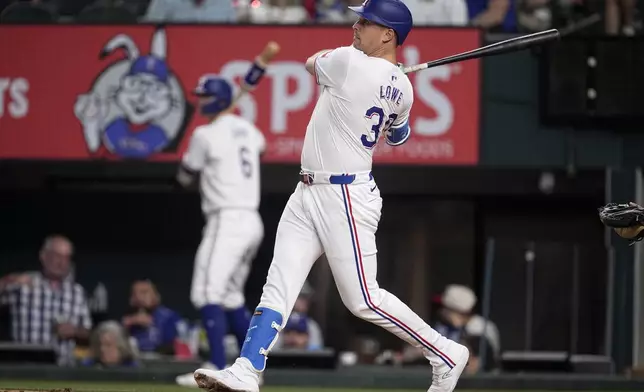 Texas Rangers' Nathaniel Lowe follows through on a run-scoring single in the fourth inning of a baseball game against the Toronto Blue Jays in Arlington, Texas, Tuesday, Sept. 17, 2024. (AP Photo/Tony Gutierrez)