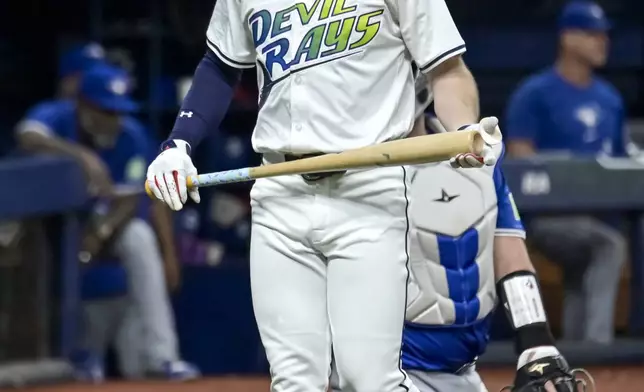 Tampa Bay Rays' Brandon Lowe walks back to the dugout after striking out against Toronto Blue Jays stater José Berríos during the third inning of a baseball game Friday, Sept. 20, 2024, in St. Petersburg, Fla. (AP Photo/Steve Nesius)