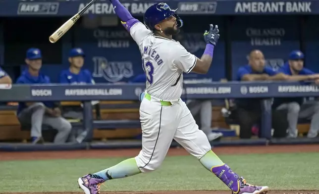 Tampa Bay Rays' Junior Caminero doubles to right field off Toronto Blue Jays starter José Berríos during the thitrd inning of a baseball game Friday, Sept. 20, 2024, in St. Petersburg, Fla. (AP Photo/Steve Nesius)