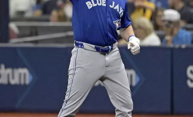 Toronto Blue Jays second baseman Spencer Horwitz gestures toward the dugout after hitting a single off Tampa Bay Rays starter Taj Bradley during the first inning of a baseball game Saturday, Sept. 21, 2024, in St. Petersburg, Fla. (AP Photo/Steve Nesius)