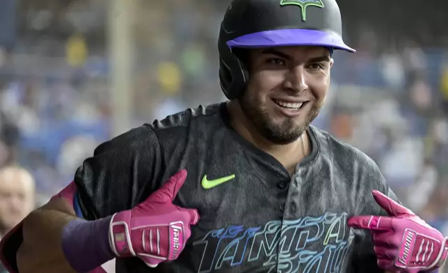 Tampa Bay Rays' Jonathan Aranda celebrates in the dugout after his two-run home run off Toronto Blue Jays starter Yariel Rodríguez during the third inning of a baseball game Saturday, Sept. 21, 2024, in St. Petersburg, Fla. (AP Photo/Steve Nesius)