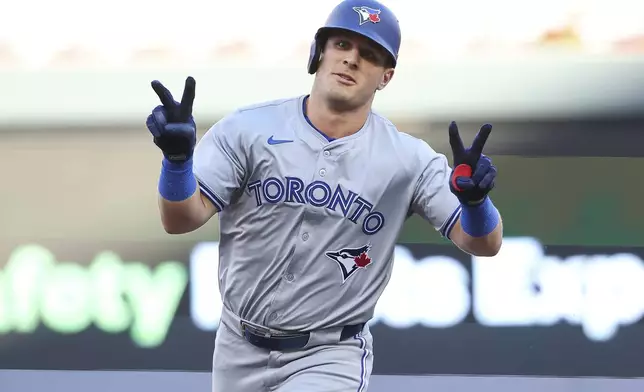 Toronto Blue Jays' Daulton Varsho celebrates his two-run home run while he runs the bases during the first inning of a baseball game against the Minnesota Twins, Saturday, Aug. 31, 2024, in Minneapolis. (AP Photo/Matt Krohn)