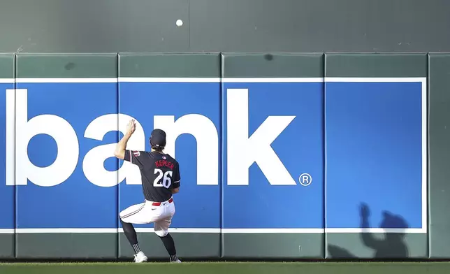 Minnesota Twins right fielder Max Kepler attempts to field the ball hit by Toronto Blue Jays' Alejandro Kirk during the first inning of a baseball game, Saturday, Aug. 31, 2024, in Minneapolis. (AP Photo/Matt Krohn)