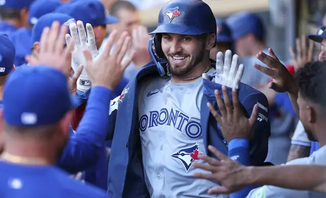 Toronto Blue Jays designated hitter Spencer Horwit celebrates his two-run home run in the dugout during the first inning of a baseball game against the Minnesota Twins, Saturday, Aug. 31, 2024, in Minneapolis. (AP Photo/Matt Krohn)