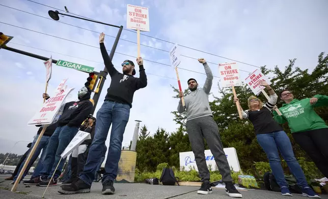 Boeing Machinists Union members and supporters wave to traffic on the picket line at the Renton assembly plant, Friday, Sept. 13, 2024, in Renton, Wash. (AP Photo/John Froschauer)