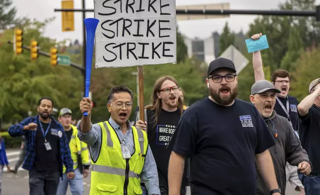 International Aerospace Machinists union members march toward the union's hall to vote on a contract offer with airplane maker Boeing, on Thursday, Sept. 12, 2024, in Renton, Wash. (AP Photo/Stephen Brashear)