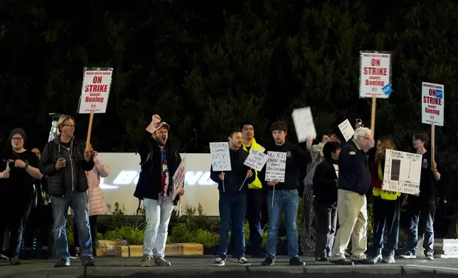 Boeing workers picket after union members voted overwhelmingly to reject a contract offer and go on strike Friday, Sept. 13, 2024, outside the company's factory in Renton, Wash. (AP Photo/Lindsey Wasson)