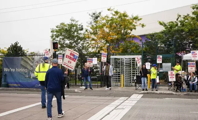 Boeing workers arrive to work the picket line as they strike Tuesday, Sept. 24, 2024, outside the company's factory in Renton, Wash. (AP Photo/Lindsey Wasson)