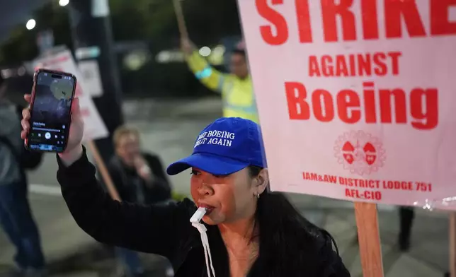 Boeing employee Ritz Amador, 40, who works as a customer coordinator, wears a "Make Boeing Great Again" cap while picketing after union members voted overwhelmingly to reject a contract offer and go on strike Friday, Sept. 13, 2024, outside the company's factory in Renton, Wash. (AP Photo/Lindsey Wasson)