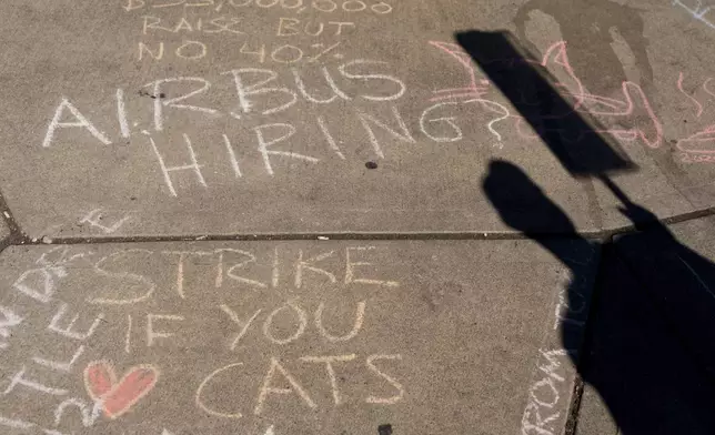 Messages written in chalk adorn the sidewalks outside of Boeing's Renton factory as employees continue to strike Tuesday, Sept. 24, 2024, in Renton, Wash. (AP Photo/Lindsey Wasson)