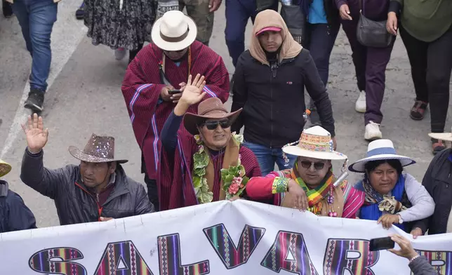 Former President Evo Morales, center, marches to the capital to protest the government of current President Luis Arce, near El Alto, Bolivia, Sunday, Sept. 22, 2024. (AP Photo/Juan Karita)