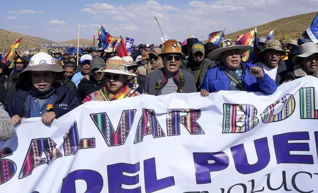 Former President Evo Morales, center, and his supporters march to the capital to protest against the government of current President Luis Arce, in an escalation of a political dispute between the two politicians, in Vila Vila, Bolivia, Tuesday, Sept. 17, 2024. (AP Photo/Juan Karita)