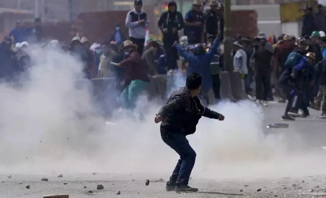 A supporter of former President Evo Morales clashes with supporters of current President Luis Arce in El Alto, Bolivia, Sunday, Sept. 22, 2024. (AP Photo/Juan Karita)