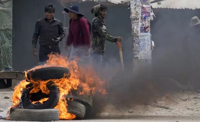 Tires burn as supporters of former President Evo Morales, face off with supporters of current President Luis Arce in El Alto, Bolivia, Sunday, Sept. 22, 2024. (AP Photo/Juan Karita)