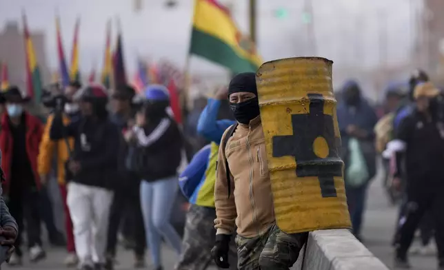 Supporters of Bolivia's President Luis Arce face off with supporters of former President Evo Morales in El Alto, Bolivia, Sunday, Sept. 22, 2024. (AP Photo/Juan Karita)