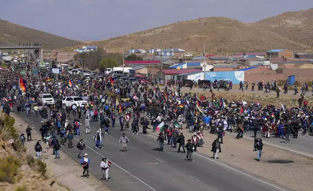 Supporters of former President Evo Morales, who are marching to the capital to protest the government of current President Luis Arce, walk toward Arce supporters who met them along the route in Vila Vila, Bolivia, Tuesday, Sept. 17, 2024. (AP Photo/Juan Karita)