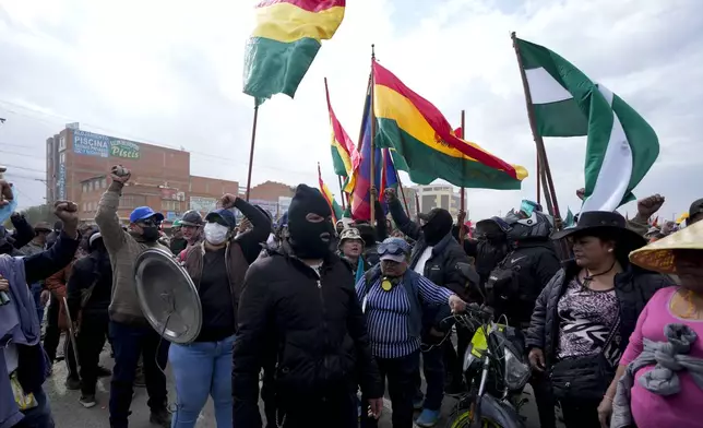 Supporters of Bolivia's President Luis Arce block supporters of former President Evo Morales from passing as they march to the capital to protest the Arce's government in El Alto, Bolivia, Sunday, Sept. 22, 2024. (AP Photo/Juan Karita)