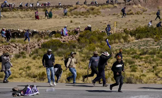 Supporters of former President Evo Morales, who are marching to the capital to protest the government of current President Luis Arce, advance towards Arce supporters who met them along their route in Vila Vila, Bolivia, Tuesday, Sept. 17, 2024. (AP Photo/Juan Karita)