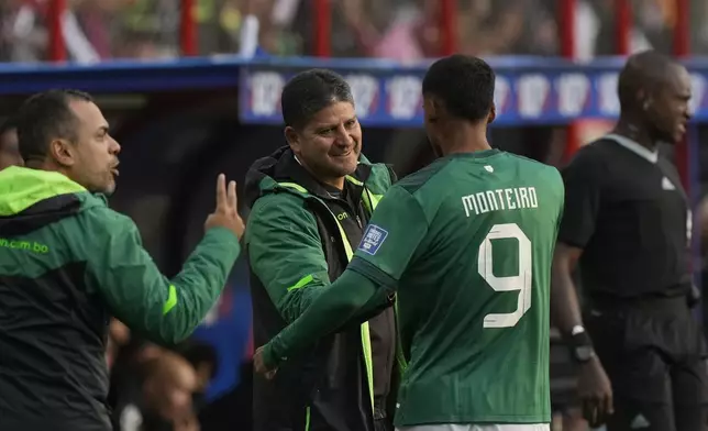 Bolivia's coach Oscar Villegas celebrates with Enzo Monteiro after their fourth goal against Venezuela during a qualifying soccer match for the FIFA World Cup 2026 at the Municipal de Villa Ingenio stadium in El Alto, Bolivia, Thursday, Sept. 5, 2024. (AP Photo/Juan Karita)